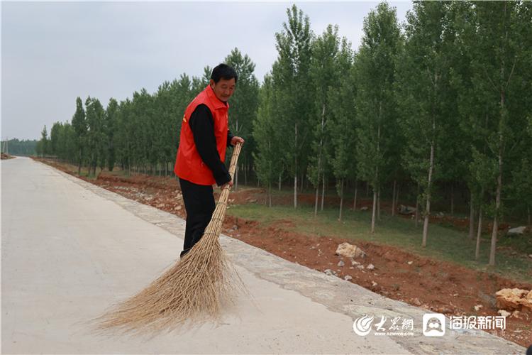 在濟寧市泗水縣苗館鎮峙山莊村村口的道路上,記者看到一位戴著紅袖章